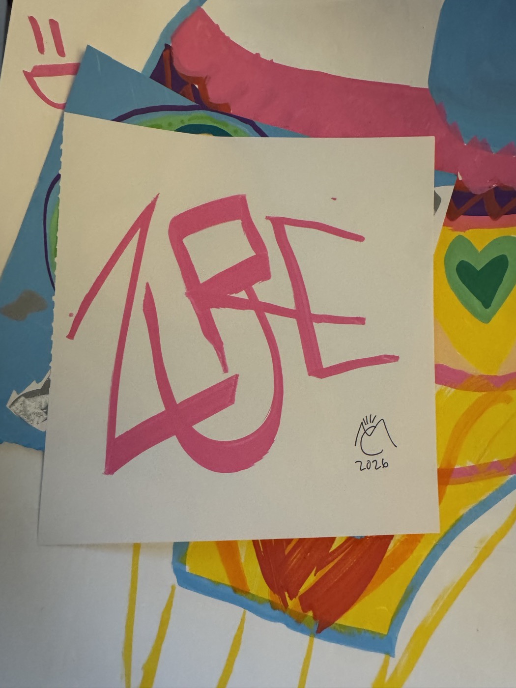 ZURC in pink marker over a blue and yellow painted sheet